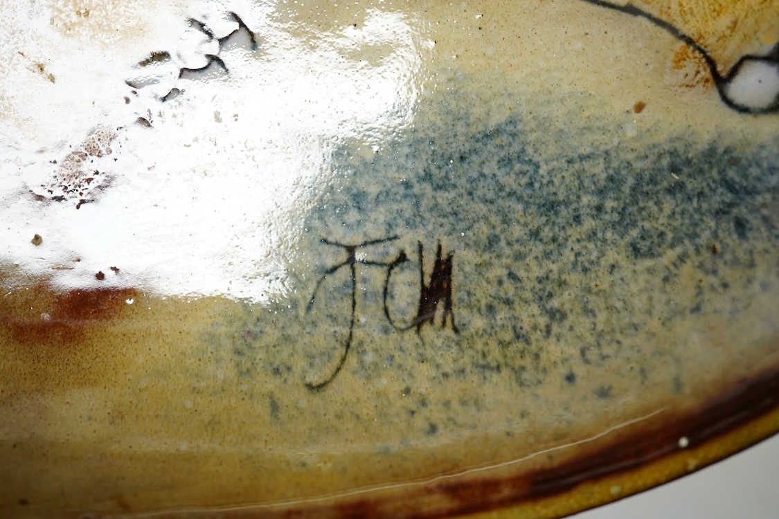 A Joyce Morgan, Chelsea pottery dish depicting a lion and lioness, monogrammed, stamped to the base, 27cm wide